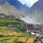 A panoramic view of the medieval stone and mud-brick houses of Kagbeni village nestled in the arid Kali Gandaki river valley on the Annapurna Circuit.
