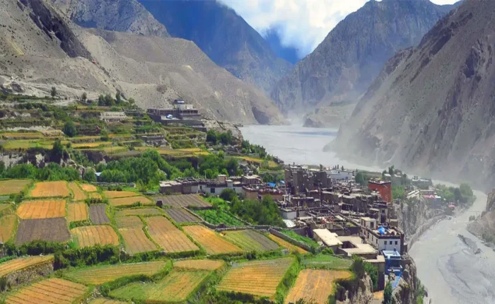 A panoramic view of the medieval stone and mud-brick houses of Kagbeni village nestled in the arid Kali Gandaki river valley on the Annapurna Circuit.
