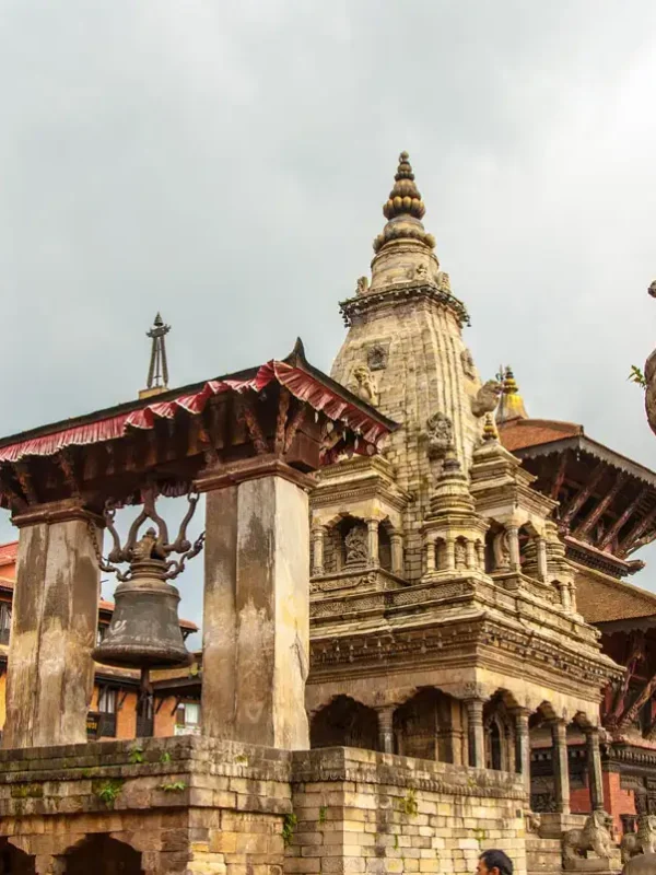 The stone-built Vatsala Durga Temple next to the famous bronze statue column of King Bhupatindra Malla in Bhaktapur Durbar Square.